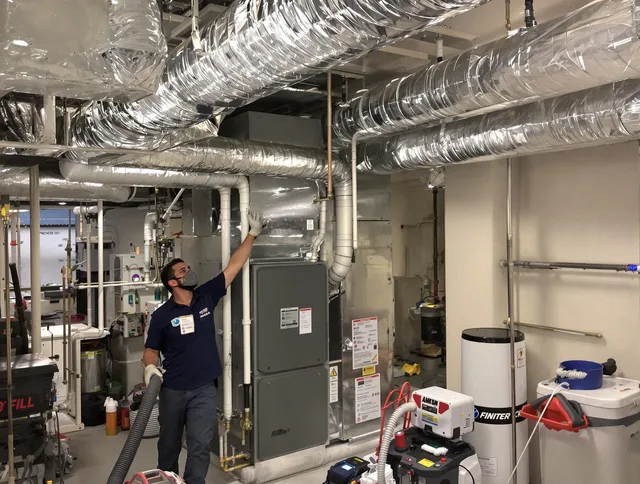 Westwood Air Duct Cleaning specialist performing thorough furnace duct cleaning in a Westwood residence